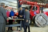 President Barack Obama with Commerce Secretary Penny Pritzker views demonstration of fiber optic spicing at Cedar Falls Utilities in Cedar Falls, Iowa. (Official White House Photo by Pete Souza) 