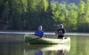 Photo of father and son fishing in canoe