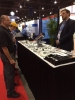 Jordan Jaeger discusses Pivot Point Fastening Solutions with a trade show attendee in Las Vegas