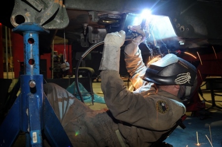 Worker Welding a Filter Housing for a Refinery