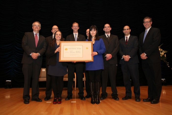 The ESA team holding their honor award aside Deputy Secretary Andrews 