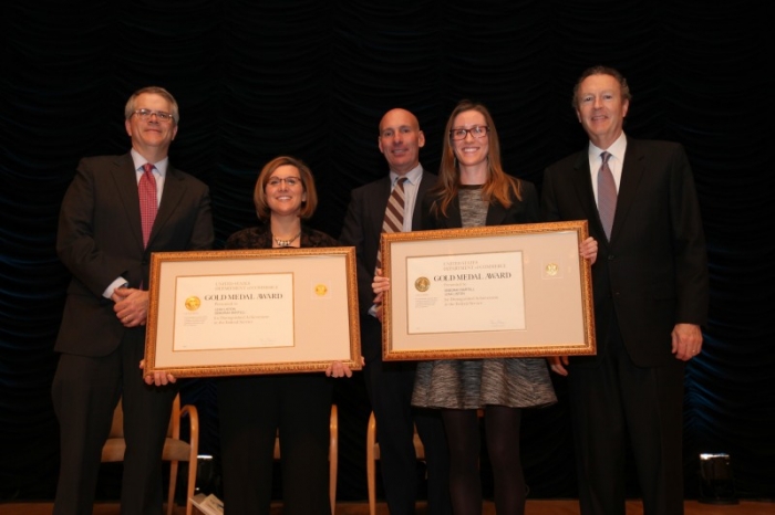 The OGC team holding their award aside Deputy Secretary Bruce Andrews.