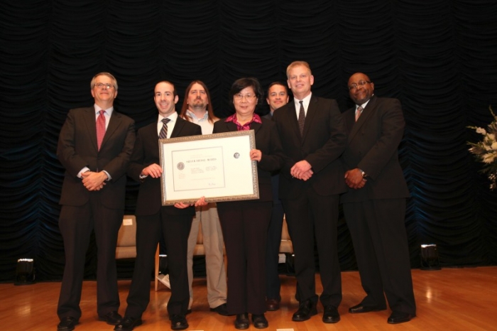 The NIST team holding their award aside Deputy Secretary Andrews.