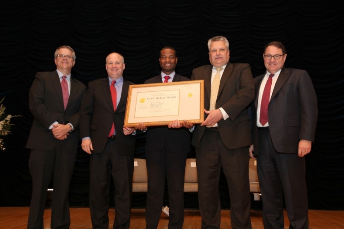 The NTIA team holding their award aside Deputy Secretary Andrews.