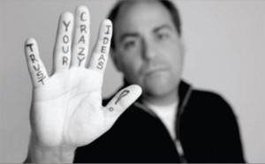 Hand with Trust Your Crazy Ideas written on it