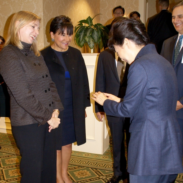 Secretary Pritzker (center) and a PAGE Ambassador (left) meet with President Park (right)