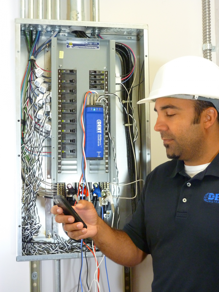 A DENT Instruments, Inc. facilities engineer uses the ELITEpro XC Power Meter to monitor consumption at an electrical panel