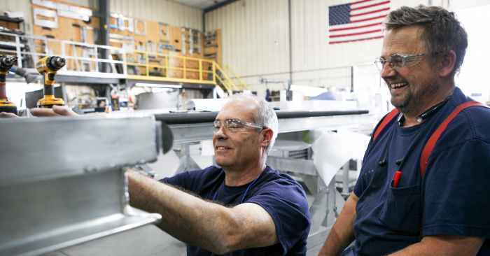 Spika employees assemble a work platform in their Central Montana facility
