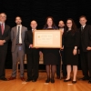 The OIG team holding their medal aside Deputy Secretary Andrews.