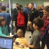 PDX Makers booth - Kids trying out a musical instrument that uses a small laser to generate notes