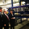Secretary Penny Pritzker (third from left) holds a hail ball next to a large machine
