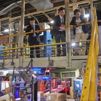 Secretary Penny Pritzker observes the work of on as FedEx employees