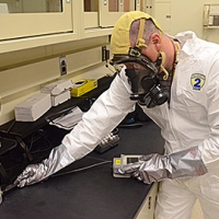 Christopher Neary of the NIST Environmental Management Group demonstrates the use of a handheld Raman spectrometer to determine the identity of an unknown sample.