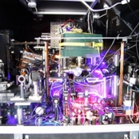  JILA’s experimental atomic clock based on strontium atoms held in a lattice of laser light is the world&#039;s most precise and stable atomic clock. The image is a composite of many photos taken with long exposure times and other techniques to make the lasers