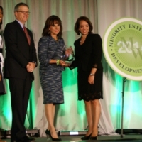 Deputy Secretary Bruce Andrews, National Director of the Minority Business Development Agency Alejandra Castillo, and MBDA Public Affairs Team Lead Velicia Woods congratulate a MED Week Award winner