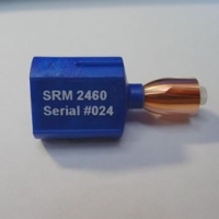A NIST Standard Reference Material 2460 standard bullet mounted on a blue stub. Each one has six signature markings typically found in a fired bullet. 