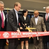 Acting Deputy Secretary of Commerce Bruce Andrews (L) is joined by Senator Bennet, Deputy USPTO Director Lee, Mayor Hancock and others at the ribbon cutting for the USPTO&#039;s Denver office