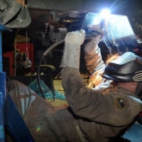 Worker Welding a Filter Housing for a Refinery