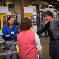Secretary Pritzker talks with employees of the Leatherman Tool Group, Inc during a tour
