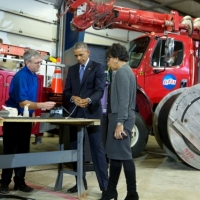 President Barack Obama with Commerce Secretary Penny Pritzker views demonstration of fiber optic spicing at Cedar Falls Utilities in Cedar Falls, Iowa. (Official White House Photo by Pete Souza) 