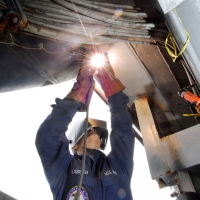 A US Navy welder works at the Puget Sound Naval Shipyard. Photo courtesy US Navy.