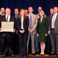 The Department of Commerce’s Energy Savings Contract Team, winner of the Lean, Clean and Green award category, pose for a photo with Ellen Herbst and Lisa Casias