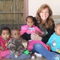 Laura Lane with Swazi children at the Heart of Africa orphanage