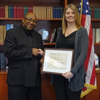 Lynda Roark receiving her award from Willie May