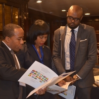 Martin Ezemma, MBDA Business Development Specialist, explains the event itinerary to a pair of attendees during the Power Africa and Agribusiness Summit Jan.13, 2016, at The National Press Club in Washington, D.C. 