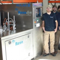 Technical and production crew posing with Resodyn Acoustic Mixers RAM 5 prior to crating for shipment to Europe