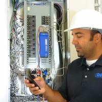 A DENT Instruments, Inc. facilities engineer uses the ELITEpro XC Power Meter to monitor consumption at an electrical panel