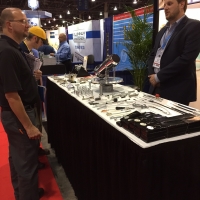Jordan Jaeger discusses Pivot Point Fastening Solutions with a trade show attendee in Las Vegas