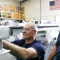 Spika employees assemble a work platform in their Central Montana facility